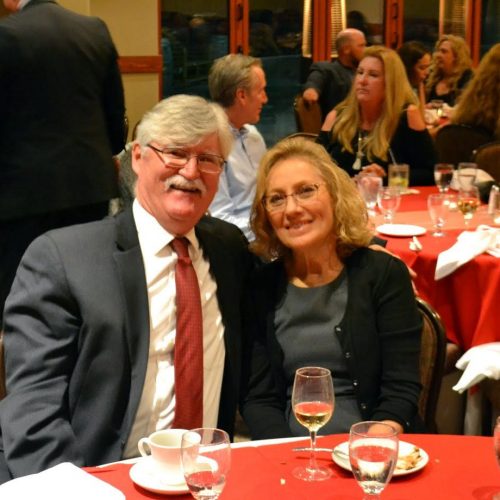 A couple sitting at a table at a party